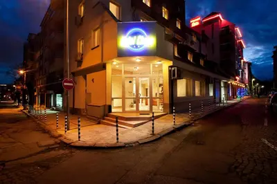 a store with a blue sign on the side of a street at Hotel Cheap - Smart choice - Great value in Sofia