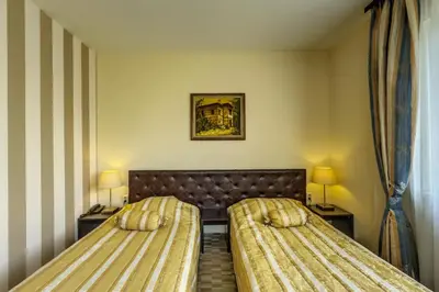 a hotel room with two beds and two lamps at Hotel Cheap - Smart choice - Great value in Sofia