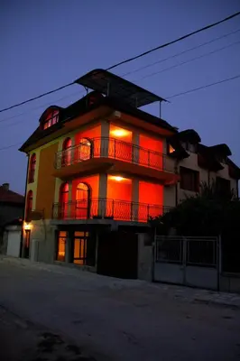 a building with red lights on the side of it at Guest House Stelia in Velingrad