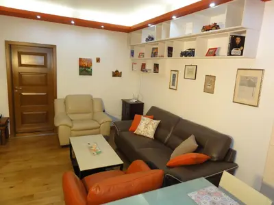 a living room with a couch and a chair at Apartment SOFIA LUX TOP CENTER in Sofia