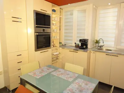 a kitchen with a table and chairs and a sink at Apartment SOFIA LUX TOP CENTER in Sofia