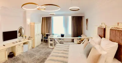 a bedroom with a bed and a desk and a table at ATLAS HOUSE Luxury Suites in Plovdiv