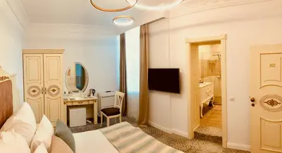 a bedroom with a bed and a bathroom with a sink at ATLAS HOUSE Luxury Suites in Plovdiv