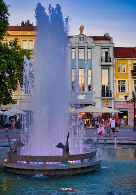 a fountain in the middle of a city with dolphins at ATLAS HOUSE Luxury Suites in Plovdiv