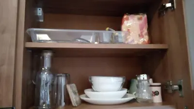 a shelf with bowls and other dishes in a cabinet at Grand Monastery - Studio Rossa in Pamporovo