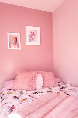 a bedroom with pink walls and a bed with a pink blanket at Baba Taki Apartment in Plovdiv