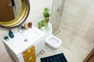 a bathroom with a sink and a toilet and a mirror at Baba Taki Apartment in Plovdiv