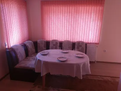 a table with plates and glasses on top at Стаи за гости Елени in Shiroki Dol