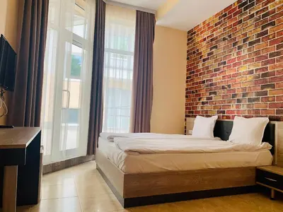 a bedroom with a brick wall and a bed at Agora Studios in Plovdiv