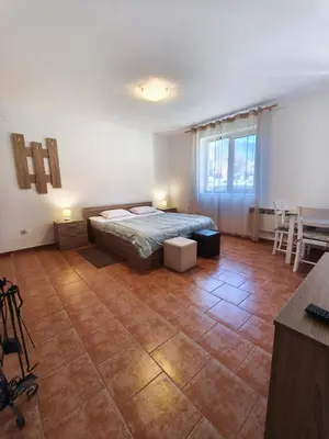 a bedroom with a bed and a table in a room at the old inn in Bansko