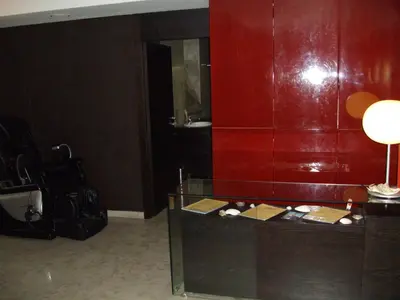 a room with a red wall and a desk with a lamp at Kokoshkovata Boutique House in Samokov