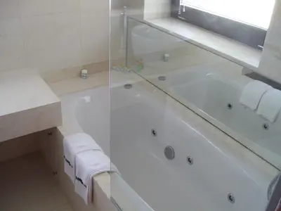 a white bath tub in a bathroom with a window at Kokoshkovata Boutique House in Samokov