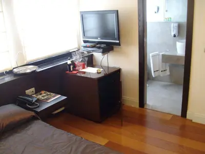 a living room with a flat screen tv and a couch at Kokoshkovata Boutique House in Samokov