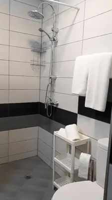 a bathroom with a shower with black and white stripes at Hotel39 in Plovdiv