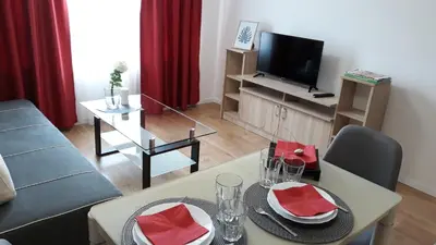 a living room with a couch and a table with chairs at Hotel39 in Plovdiv