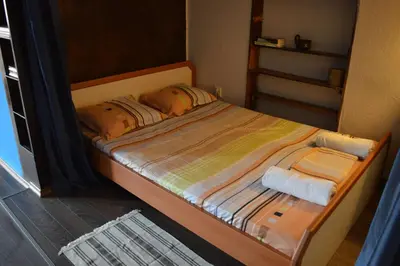 a small bed with two pillows on it in a room at Mansard Art Studio - Central Sofia in Sofia