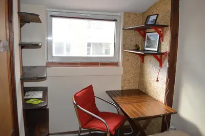 a room with a table and a chair and a window at Mansard Art Studio - Central Sofia in Sofia
