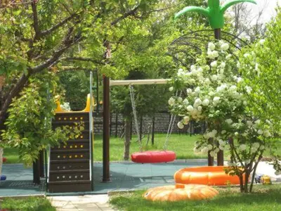 a park with a playground with a swing at Hotel Villa Ofir in Sandanski