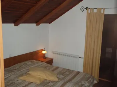 a bedroom with a bed with a yellow pillow at Saint George Holiday Village in Borovets