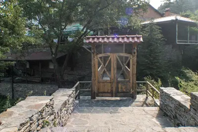 an entrance to a building with a wooden door at комплекс ВОДОПАДА in Plovdiv