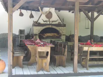 a table and chairs with a fireplace in a room at комплекс ВОДОПАДА in Plovdiv