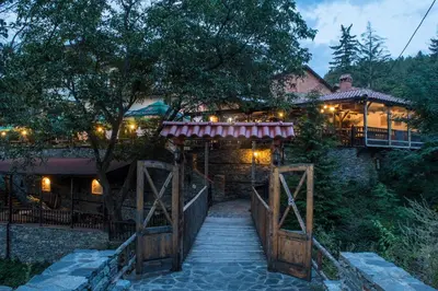 a wooden bridge over a walkway in front of a house at комплекс ВОДОПАДА in Plovdiv