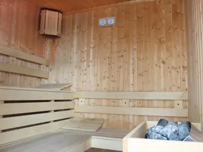 a wooden sauna with a tub in the middle at Хотел Аква Варвара in Varvara