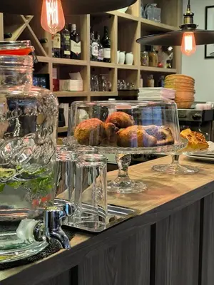 a counter top with glasses and food on it at Хотел Аква Варвара in Varvara