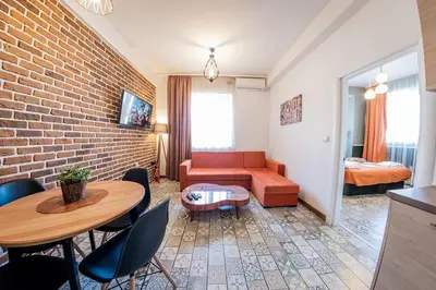 a living room with a couch and a table at Sofia Vintage Life Apartment in Sofia