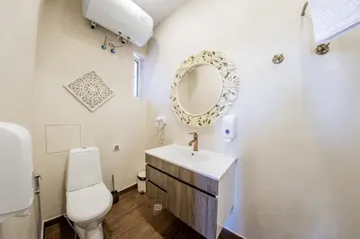 a bathroom with a sink and a mirror on the wall at Sofia Vintage Life Apartment in Sofia
