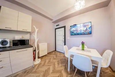 a kitchen and dining room with a table and chairs at Sofia Violet Life Apartment in Sofia