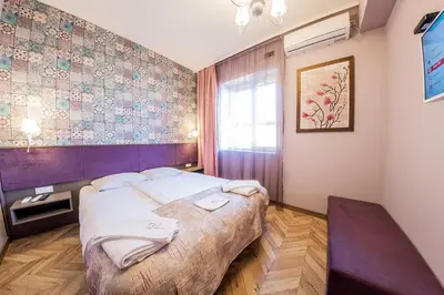 a bedroom with a large bed in a room at Sofia Violet Life Apartment in Sofia