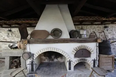 a stone oven with pots and pans on top at Djudjeva Kyshta Hotel in Panagyurishte