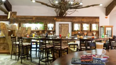 a restaurant with a table with a piece of cake on it at Wine & Spa Complex Starosel in Starosel