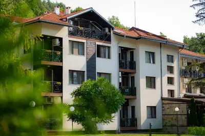 a large white building with balconies on it at Ostrova Holiday Village in Beli Osŭm