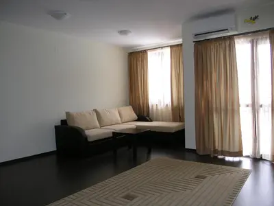 a living room with a couch and a table at Ostrova Holiday Village in Beli Osŭm
