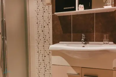 a bathroom with a sink and a shower at Ostrova Holiday Village in Beli Osŭm