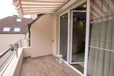 a balcony with a sliding glass door on a house at Апартамент Радост Сандански in Sandanski