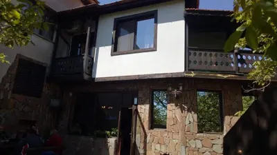 a house with a balcony on top of it at Семеен хотел НАЦИОНАЛ in Mineralni Bani