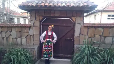 a woman is standing in front of a door at Семеен хотел НАЦИОНАЛ in Mineralni Bani