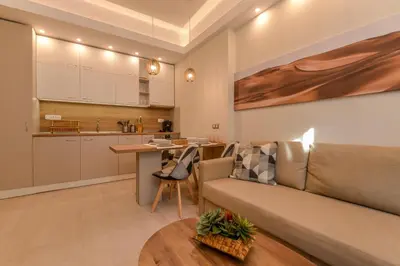 a living room with a couch and a kitchen at Sofia Dream Apartment - Premium One Bedroom on Ekzarh Yosif by Flat Mаnager in Sofia