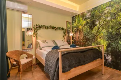 a bedroom with a bed and a painting on the wall at Chic 1BR with Terrace in Sofia City Center by Flat Mаnager in Sofia