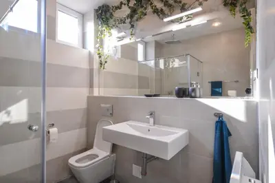 a white bathroom with a sink and a toilet at Chic 1BR with Terrace in Sofia City Center by Flat Mаnager in Sofia