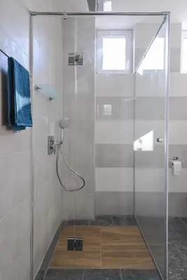 a shower with a glass door in a bathroom at Chic 1BR with Terrace in Sofia City Center by Flat Mаnager in Sofia