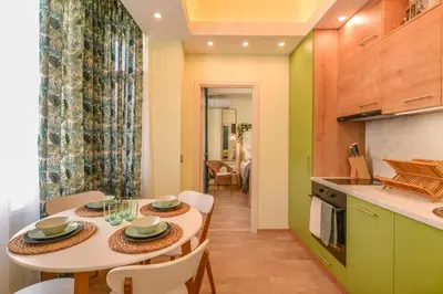 a kitchen and dining room with a table and chairs at Chic 1BR with Terrace in Sofia City Center by Flat Mаnager in Sofia