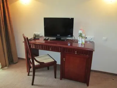 a desk with a television on top of it at Downtown Alexander Services Apartments in Bansko