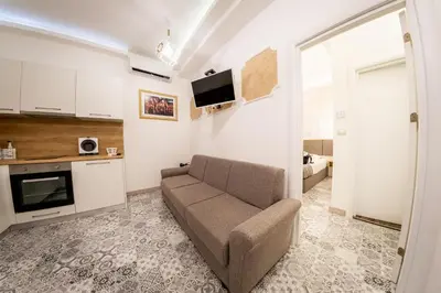 a living room with a couch and a tv at Sofia Pearl Life Apartment - No Window Apartment in Sofia