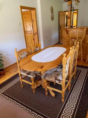 a wooden table and chairs in a room at вила Здравец in Yagodina