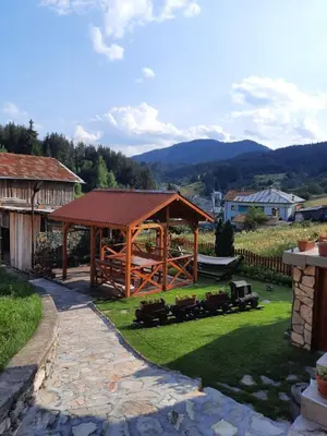 a wooden gazebo in a yard with green grass at вила Здравец in Yagodina