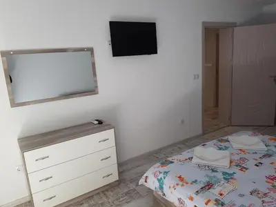 a bedroom with a bed and a tv on the wall at United Apartments 2 in Sandanski
